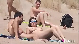 Sol fucks a panhandler in a beach surrounded by voyeurs