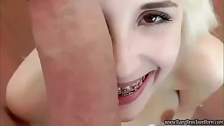 Young looking teen handles a hefty cock